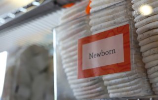 Newborn diapers in a bin